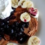 Vegan chocolate pancakes with blueberry sauce